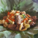 Cambodian chicken and mixed vegetables served on a fresh green lotus leaf at a rural eatery near Kampong Thom.