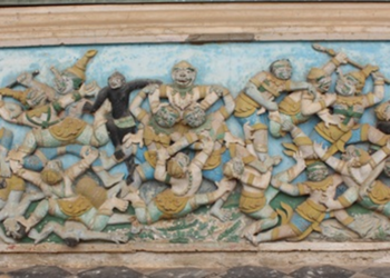 Ancient relief carving depicting Rama's monkey army warriors in dynamic battle poses from Wat Damrei Sa temple in Battambang Cambodia