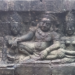 Bas-relief of Yama seated with attendants on the Terrace of the Leper King at Angkor Thom, Cambodia, carved in weathered sandstone with intricate Khmer details.