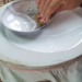 Woman spreading rice batter on steamer for traditional Cambodian rice paper production in Battambang