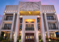 Elegant front facade of Memoire Siem Reap Hotel at sunset with Khmer architectural details, illuminated balconies, and welcoming entrance on National Road 6 near Angkor Wat in Siem Reap, Cambodia