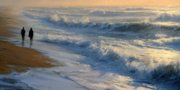 Two people walking along a wet sandy beach at dusk beside foaming waves, with golden light from the setting sun reflecting on the ocean and low clouds in the distance.