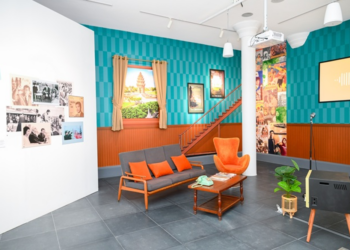 Retro Khmer living room set with orange armchairs, sofa and vintage TV forming a karaoke corner at the “Angkêt de mots: When Khmer Meets French” exhibition in Phnom Penh.