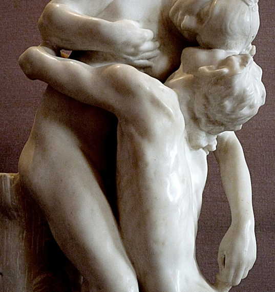 Marble sculpture Shakuntala by Camille Claudel showing two nude lovers locked in a tender embrace, inspired by Kalidasa’s Sanskrit play, against a neutral museum background.