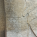 Close view of an Preah Khan Apsara sandstone skirt showing grid based Kbach floral motifs that resemble elements of the modern Louis Vuitton monogram.