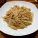 Cambodian stir-fried lotus stem with ground pork on a white plate over a wooden table