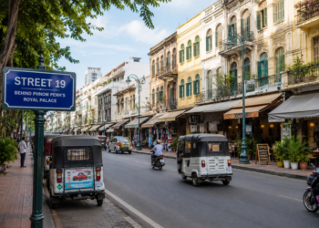 Street 19 in Phnom Penh behind the Royal Palace with shops, tuk-tuks, and colonial-style buildings