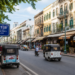 Street 19 in Phnom Penh behind the Royal Palace with shops, tuk-tuks, and colonial-style buildings