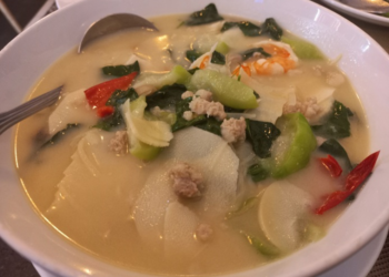 Traditional Cambodian bamboo shoot soup with bamboo shoots, shrimp, minced pork, leafy greens, and vegetables served in a light broth.