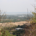 Panoramic view of the Cambodian countryside from the top of Phnom Basith in Kandal Province, showing forests, fields, and distant landscapes under a clear sky.