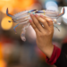 A hand holds a fresh blue swimming crab against the softly blurred lights of Kep’s seafood market, capturing the vibrant atmosphere of Cambodia's coastal fishing community. Photo by Aurélie Fischer, courtesy of Art for Kep.