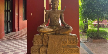 Statue of King Sisowath seated in a traditional Khmer pose at the Royal University of Fine Arts in Phnom Penh, Cambodia.