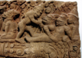 Khmer-style stone relief depicting the death of Valin, with the monkey king surrounded by other figures in a dramatic battle scene.