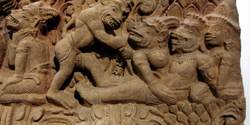 Khmer-style stone relief depicting the death of Valin, with the monkey king surrounded by other figures in a dramatic battle scene.