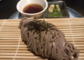 Soba noodles served on a bamboo mat with dipping sauce, wasabi, and nori at Iza restaurant, Rosewood Phnom Penh.