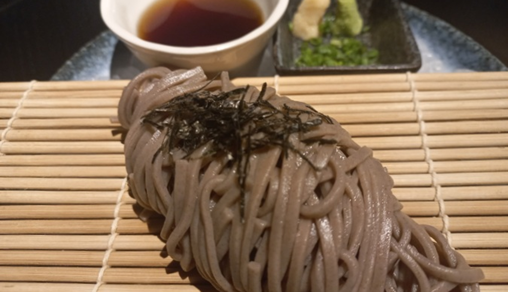Soba noodles served on a bamboo mat with dipping sauce, wasabi, and nori at Iza restaurant, Rosewood Phnom Penh.