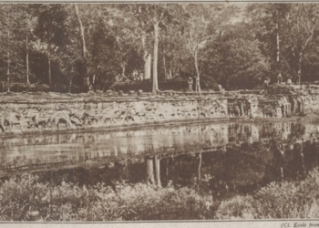 Historic ca. 1938 photograph of the Terrace of the Elephants in Angkor Thom, Cambodia, showing Khmer carvings, trees, and reflected water.