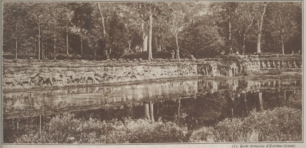 Historic ca. 1938 photograph of the Terrace of the Elephants in Angkor Thom, Cambodia, showing Khmer carvings, trees, and reflected water.