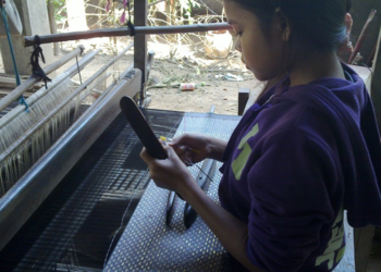 Young Cambodian weaver working at a traditional loom on Koh Dach, Silk Island