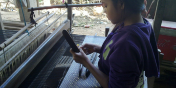 Young Cambodian weaver working at a traditional loom on Koh Dach, Silk Island