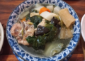 A bowl of Cambodian chap chay with vegetables, pork, tofu skin, and wood ear mushrooms.