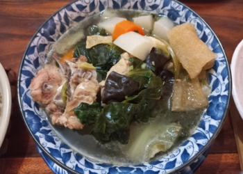 A bowl of Cambodian chap chay with vegetables, pork, tofu skin, and wood ear mushrooms.