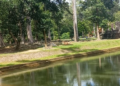 Eastern façade of Bayon Temple reflected in the moat at Angkor Thom, Cambodia