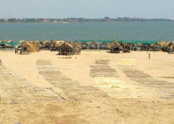 Thatched picnic huts and woven mats along the Mekong River on Koh Dach, Cambodia