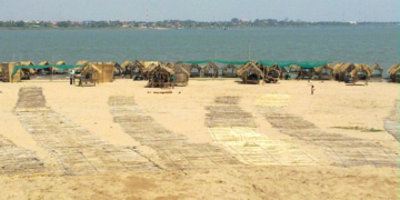 Thatched picnic huts and woven mats along the Mekong River on Koh Dach, Cambodia