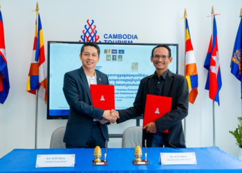Representatives of the Cambodia Tourism Board and Chaktomuk Short Film Festival shake hands after signing a tourism and film promotion agreement in Phnom Penh.