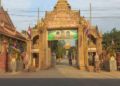 Entrance gate of Wat Prek Bangkang in Kandal Province, Cambodia, featuring two large golden Mekong lobster statues instead of traditional elephant or lion guardians.