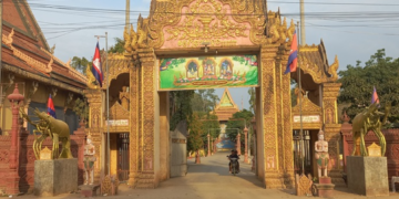 Entrance gate of Wat Prek Bangkang in Kandal Province, Cambodia, featuring two large golden Mekong lobster statues instead of traditional elephant or lion guardians.