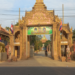 Entrance gate of Wat Prek Bangkang in Kandal Province, Cambodia, featuring two large golden Mekong lobster statues instead of traditional elephant or lion guardians.