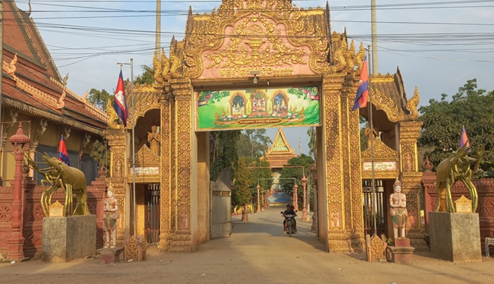 Entrance gate of Wat Prek Bangkang in Kandal Province, Cambodia, featuring two large golden Mekong lobster statues instead of traditional elephant or lion guardians.