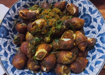 Plate of Cambodian sea snails stir-fried with herbs, spices, and seasoning.