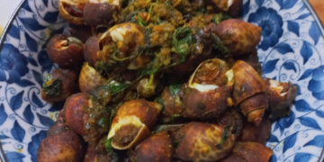 Plate of Cambodian sea snails stir-fried with herbs, spices, and seasoning.
