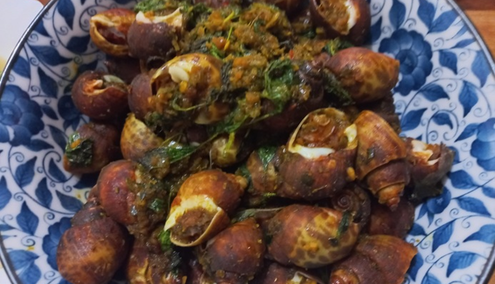 Plate of Cambodian sea snails stir-fried with herbs, spices, and seasoning.