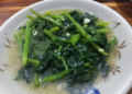 Malabar spinach sautéed with garlic served on a plate in Phnom Penh, Cambodia