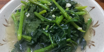 Malabar spinach sautéed with garlic served on a plate in Phnom Penh, Cambodia