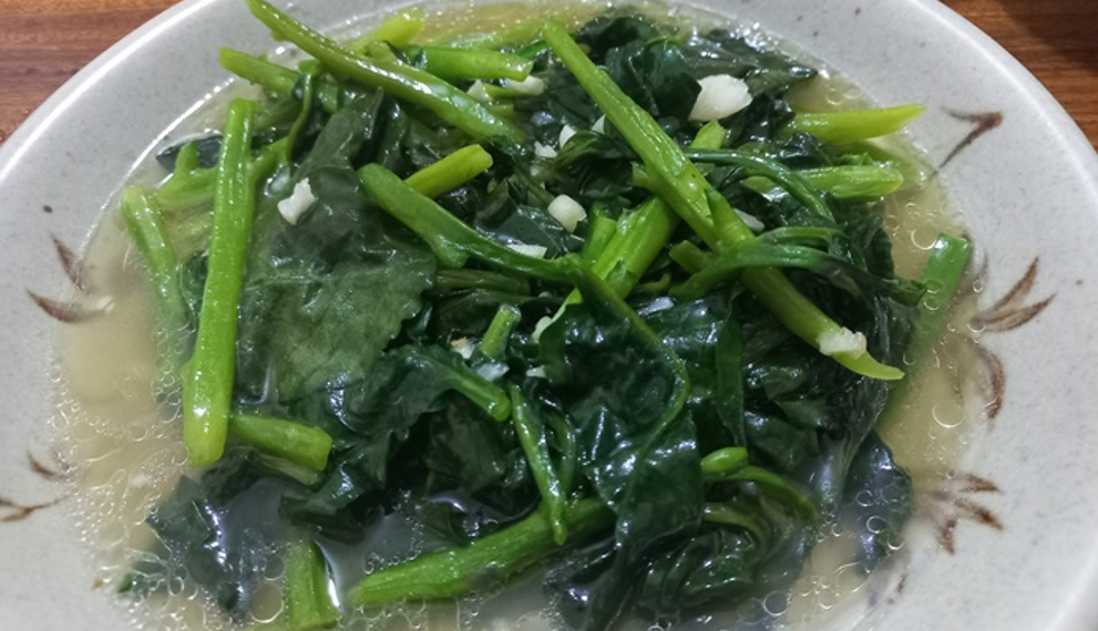 Malabar spinach sautéed with garlic served on a plate in Phnom Penh, Cambodia