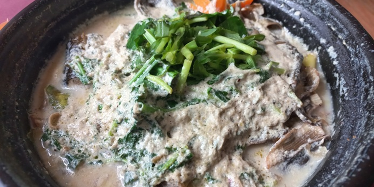 Steamed eel with banana flower, herbs, and creamy Khmer sauce at Neari Khmer Restaurant in Siem Reap, Cambodia.