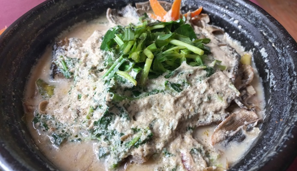 Steamed eel with banana flower, herbs, and creamy Khmer sauce at Neari Khmer Restaurant in Siem Reap, Cambodia.
