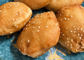 Cambodian sesame hollow doughnuts called នំប៉ោង on a blue plate in Phnom Penh